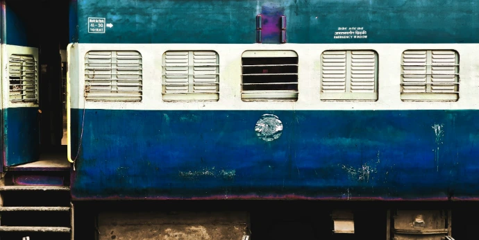 blue, white, and green train coach